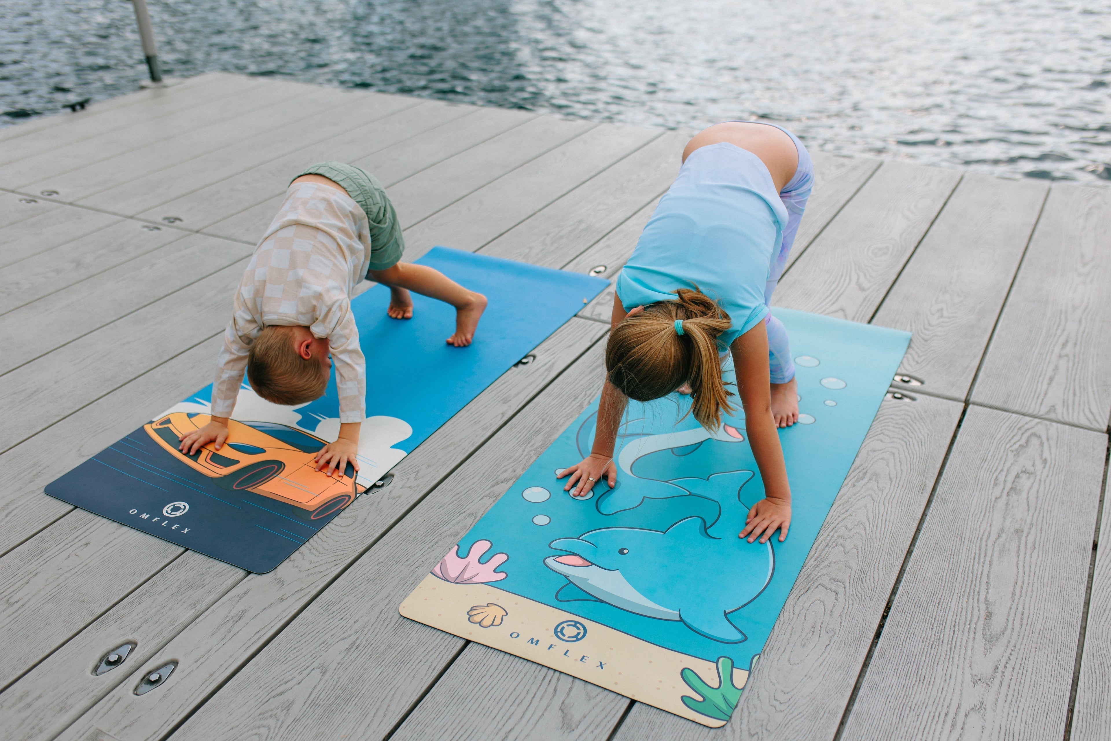 Calm children practicing yoga on a kids mat